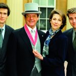 Sir Roger Moore receiving the CBE